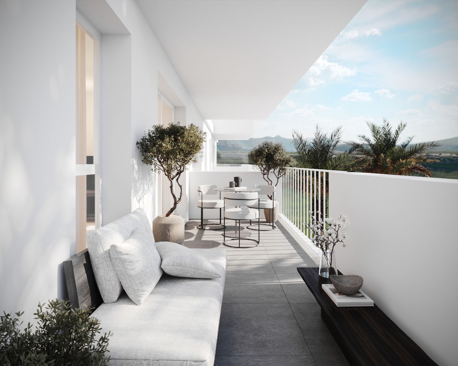 Modern balcony with white furniture, potted trees, and mountain views.